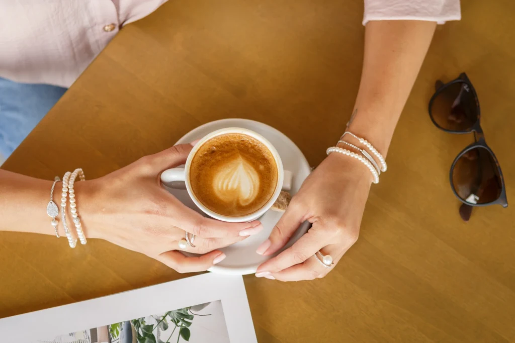 Perlearmbånd ved en kop kaffe